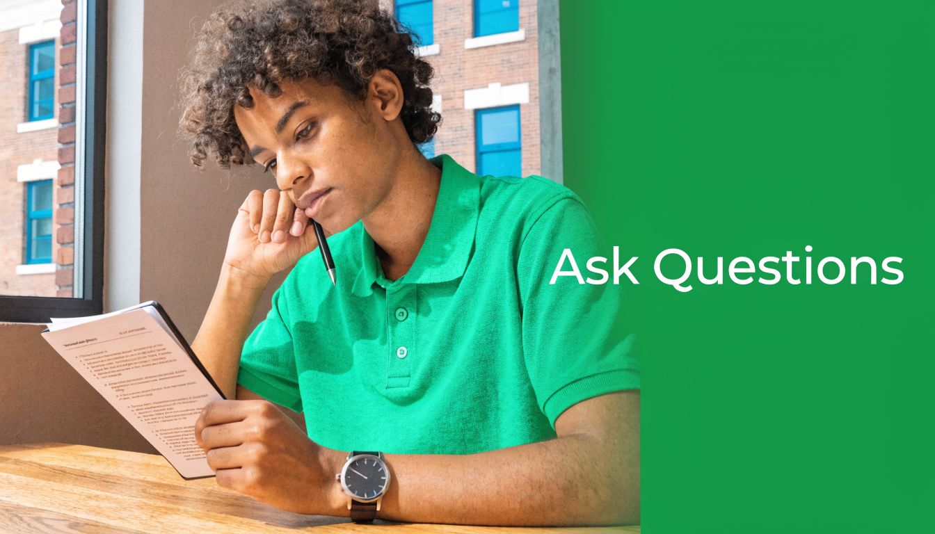 A young person with curly hair studying with a digital tablet while wearing a green shirt.