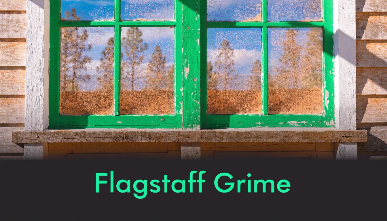 A close-up view of an old wooden window frame painted bright green with dust-covered window panes.